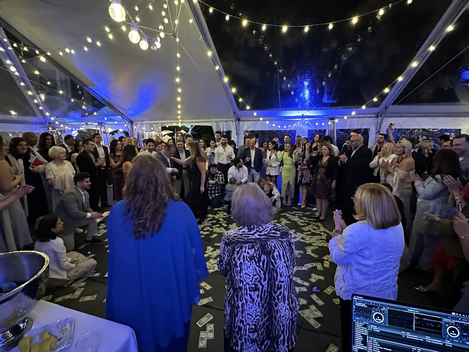 Family circling the dance floor during a Greek celebration